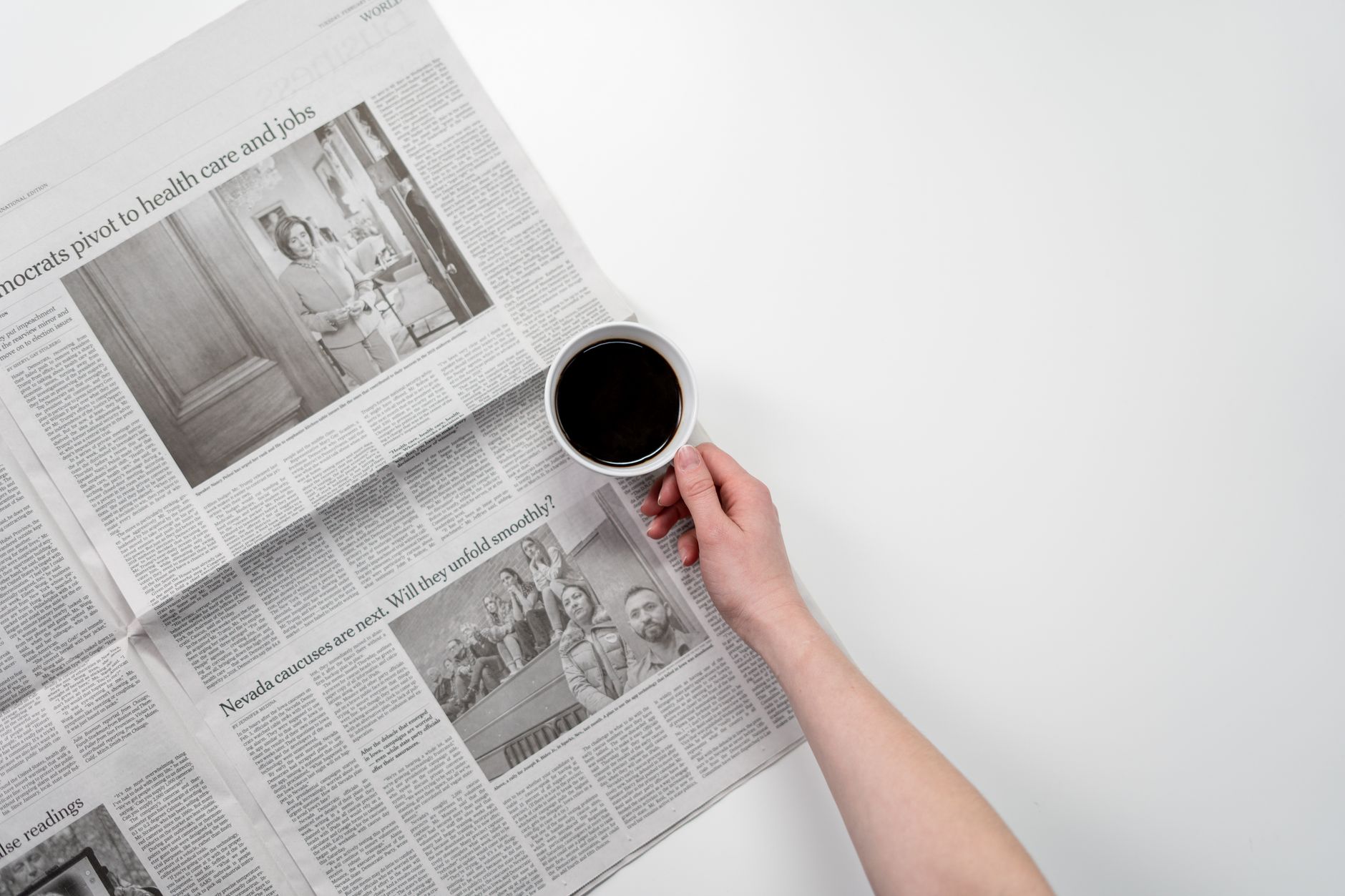 Hand holding a black coffee over newspaper, perfect for business and morning themes. — Choosing a Paper Writing Service