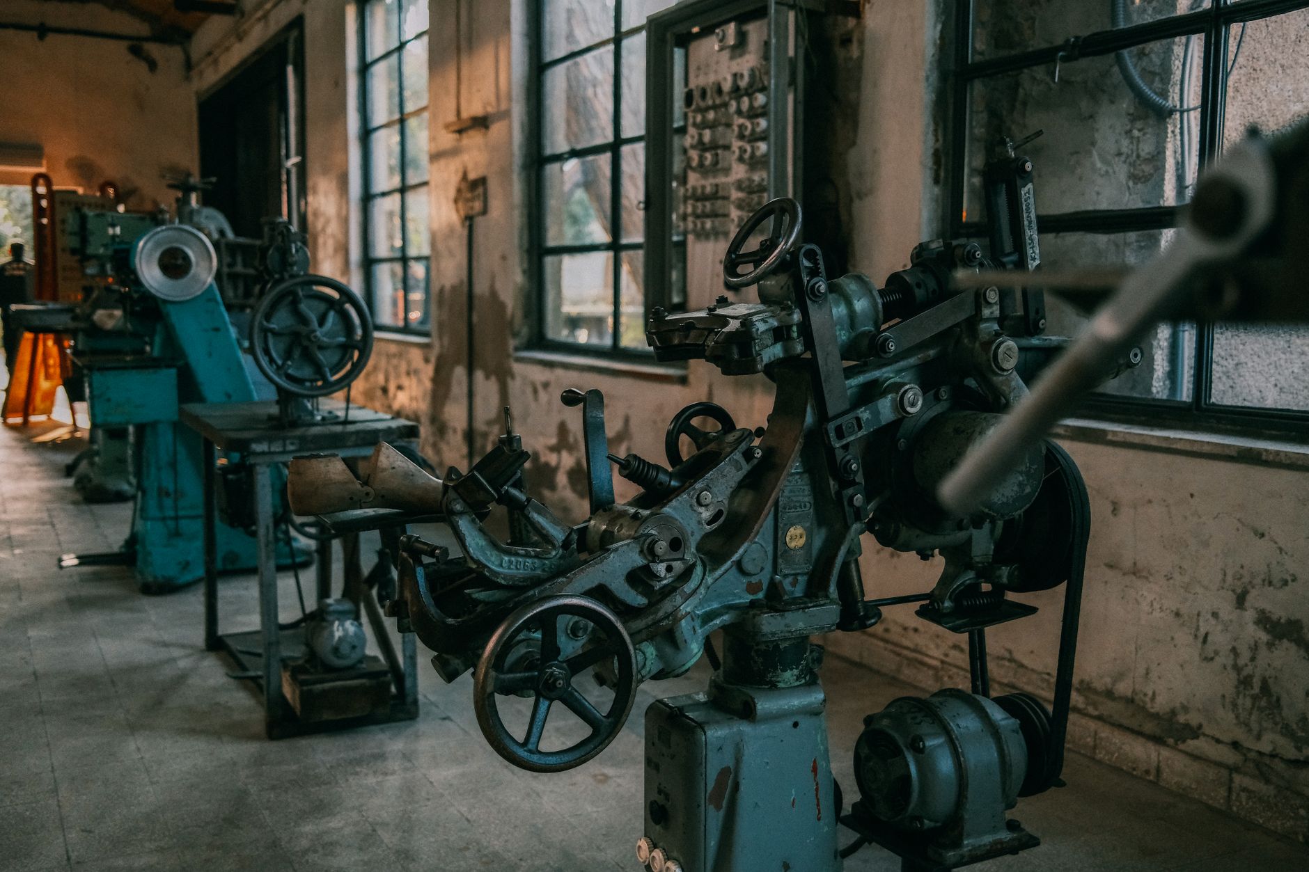 Old industrial machines in an abandoned workshop with vintage tools and equipment. — How Industrial Solvents Are Shaping Mode