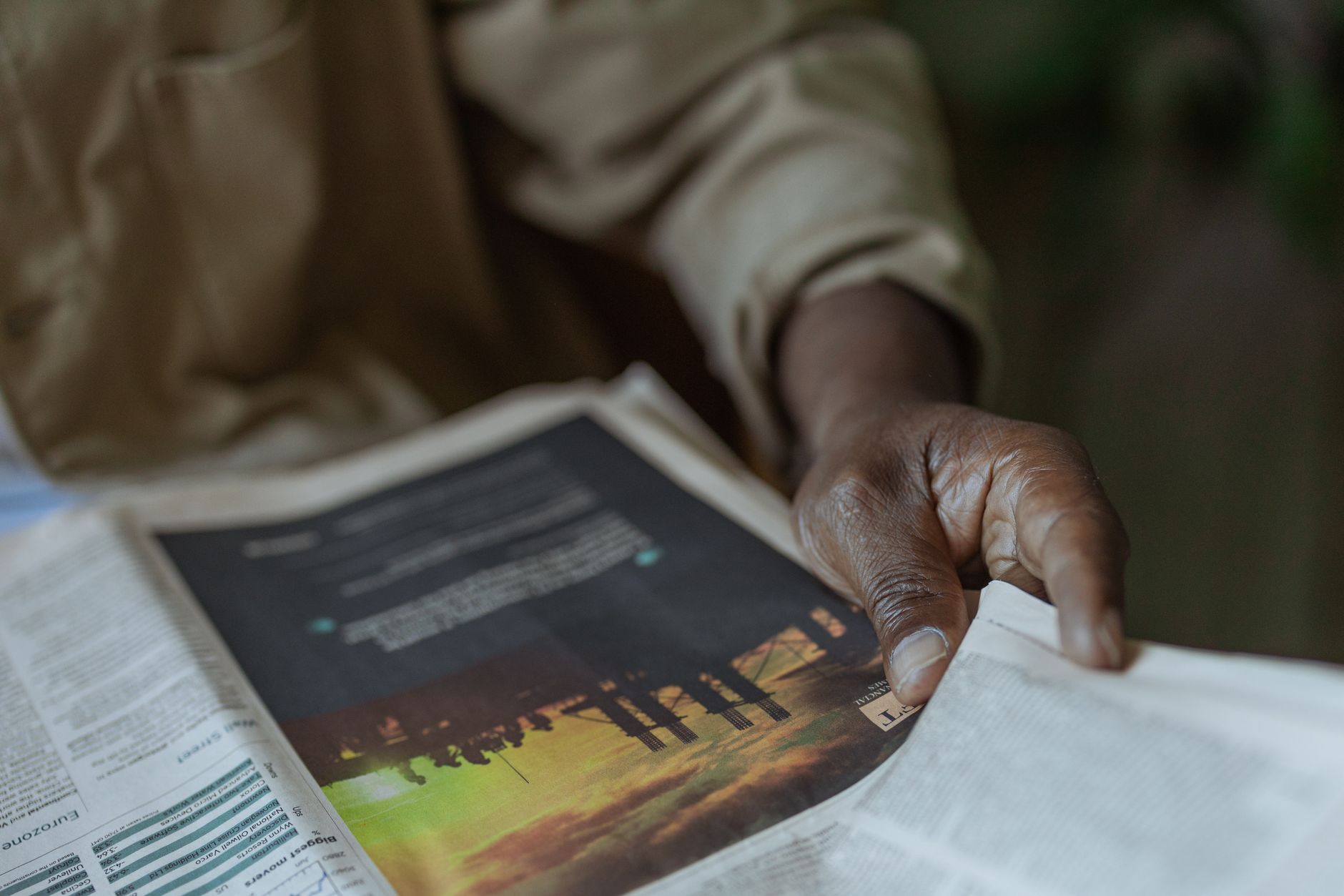 Detailed close-up of a person holding and reading a newspaper indoors. — Urgent Essay Writing Service - Do You Need One?